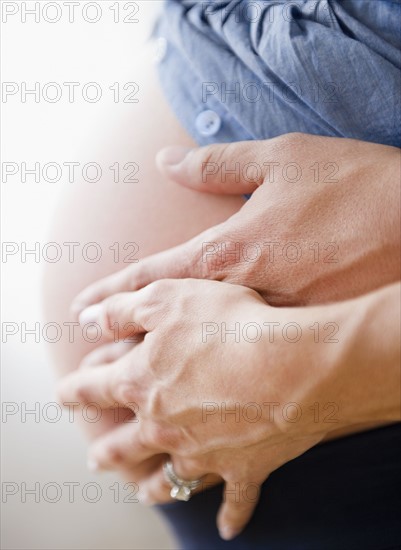 Young man hugging pregnant woman. Photo : Jamie Grill