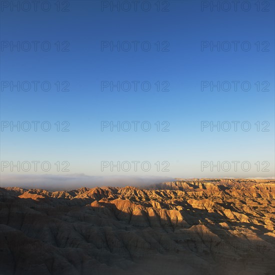 USA, South Dakota, Mountains in morning fog in Badlands National Park.