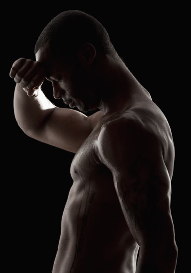 Studio shot of tired shirtless man. Photo: Mike Kemp