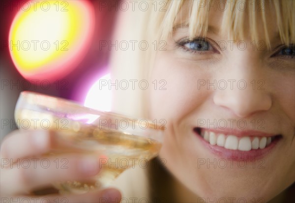 Young woman drinking champagne. Photo: Jamie Grill Photography