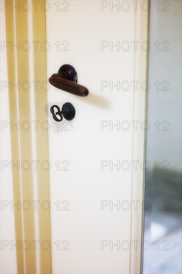 close-up of antique door with handle and lock.