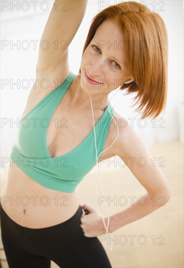 Woman exercising and listening to music. Photo: Jamie Grill Photography