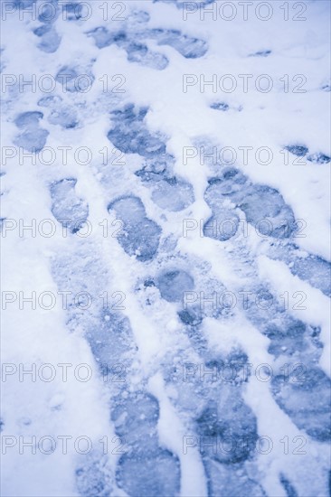 USA, New York City, Close-up view of footprints in snow. Photo: Kristin Lee