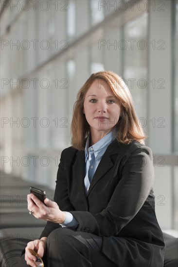 Businesswoman text-messaging. Photo: Mark Edward Atkinson