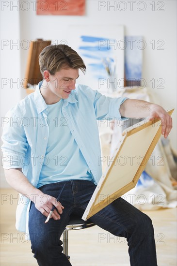 Man painting picture in studio. Photo : Daniel Grill