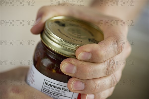 Man opening jar.