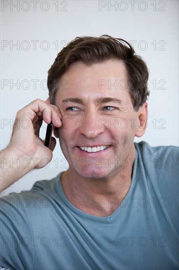 Portrait of mature man with mobile phone. Photo: Rob Lewine