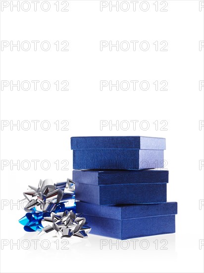 Stack of blue boxes with ribbons, studio shot. Photo: David Arky