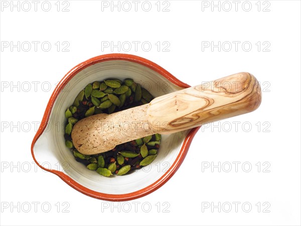 Studio shot of mortar and pestle with cardamom seeds. Photo: David Arky