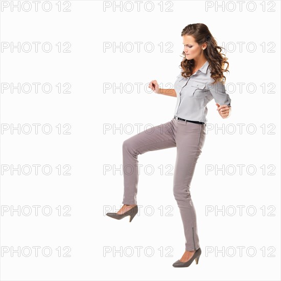 Studio shot of excited young woman on white background. Photo: momentimages