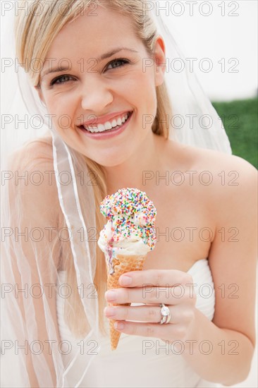 Portrait of young bride eating ice cream. Photo: Jamie Grill