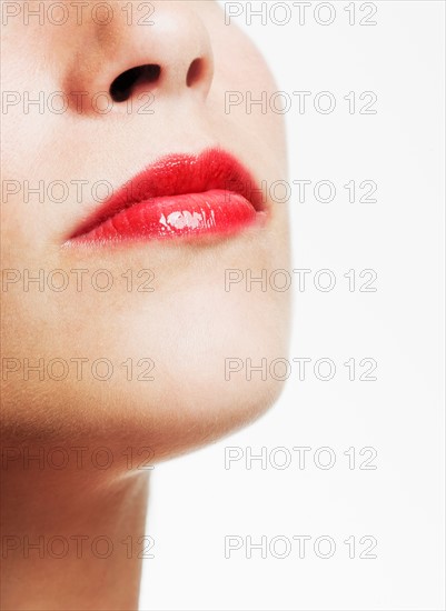 Studio shot of young woman wearing red lipstick.