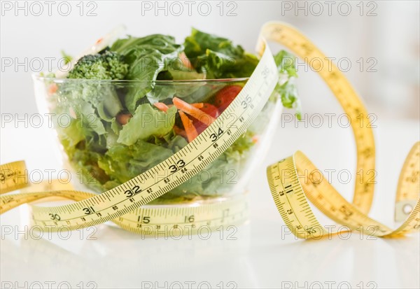 Bowl of salad and tape measure. Photo : Jamie Grill