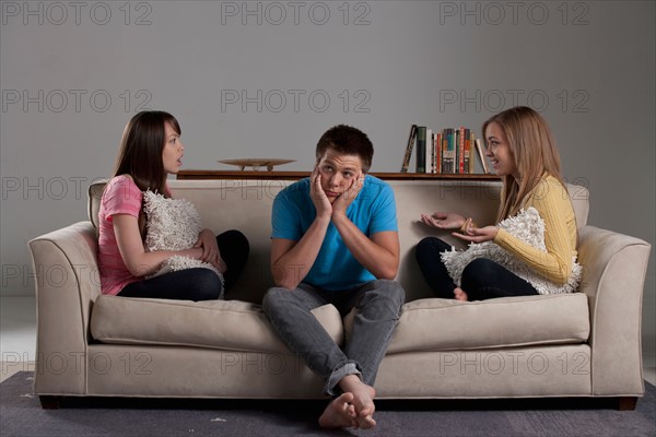 Portrait of teenage boy (16-17) and girl (16-17) with young friend. Photo: Rob Lewine