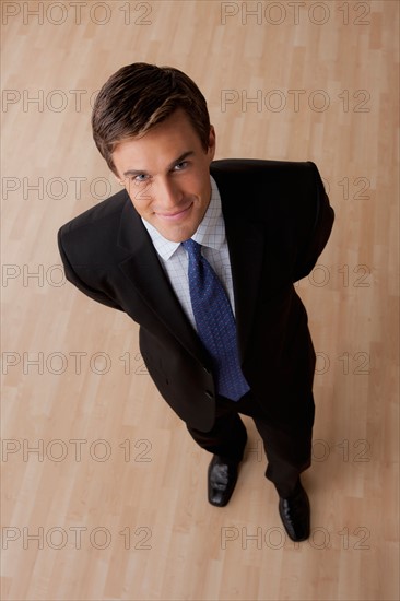 Portrait of young businessman smiling. Photo: Rob Lewine