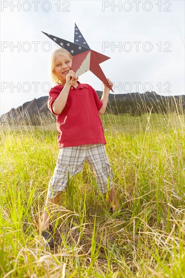 Boy (6-7) playing with star with American flag pattern. Photo: Shawn O'Connor