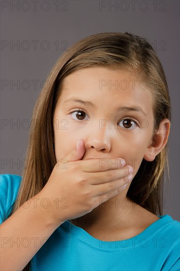 Portrait of surprised girl (8-9), studio shot. Photo : Rob Lewine