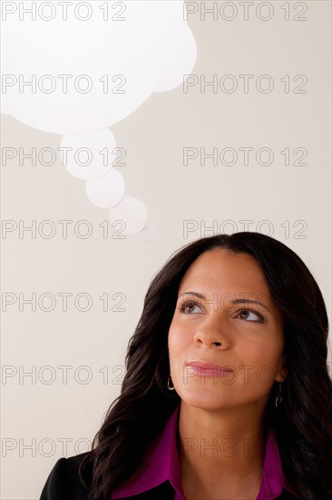 Studio portrait of businesswoman with thought bubble. Photo : Rob Lewine