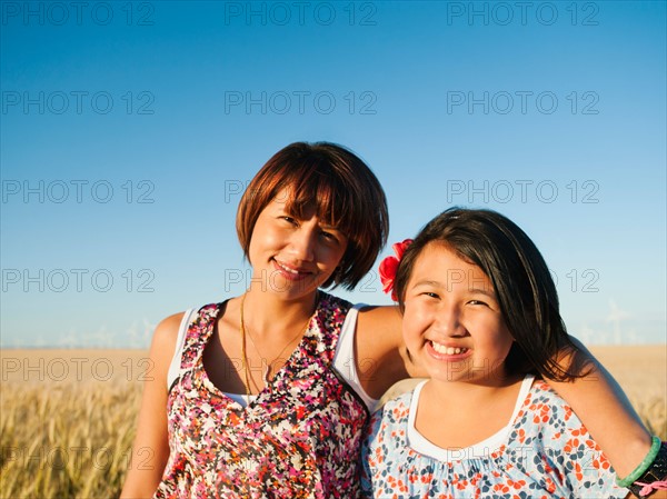 Mother and daughter (10-11) standing in wheat field . Photo: Erik Isakson