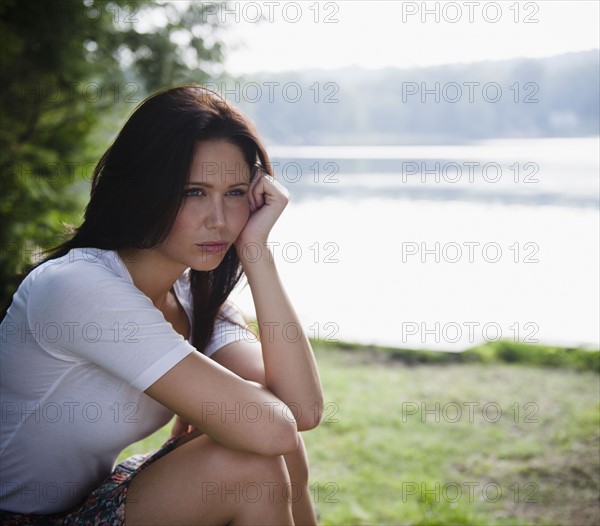 Roaring Brook Lake, Lonely woman sitting by lake. Photo: Jamie Grill