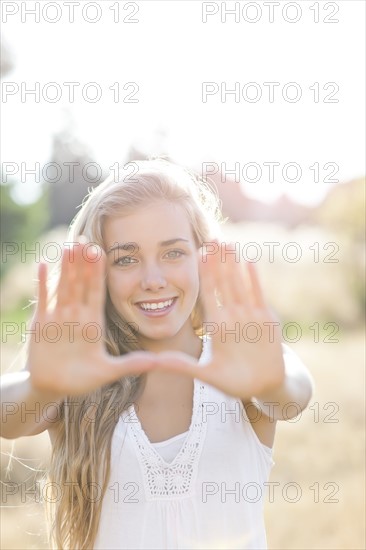 Teenage girl (16-17) displaying stop gesture. Photo: Take A Pix Media