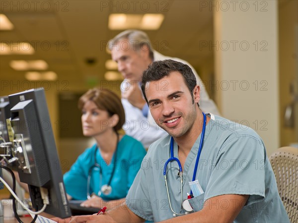 Doctor and surgeons working on computers in hospital. Photo: db2stock