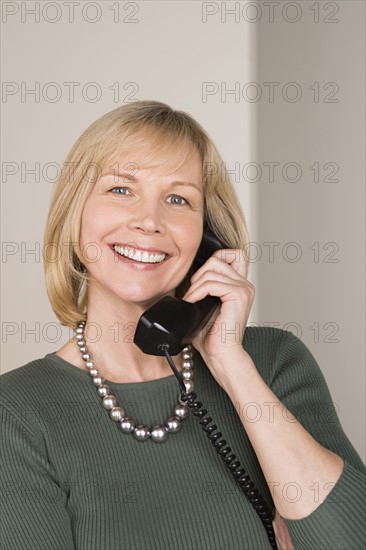 Portrait of businesswoman talking on phone. Photo: Rob Lewine