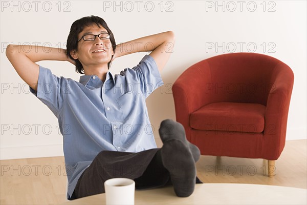 Man sitting with feet up on desk. Photo : Rob Lewine