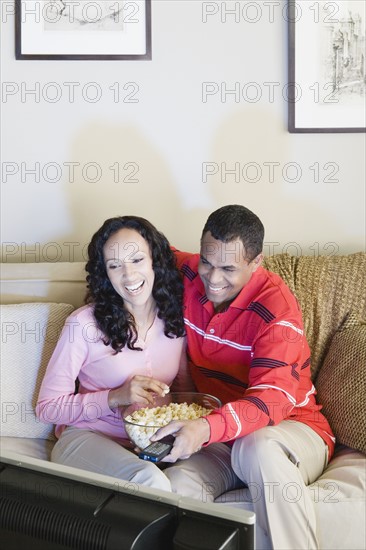 Couple watching tv. Photo: Rob Lewine