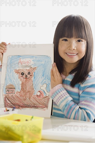 Girl (6-7) showing her drawing. Photo: Rob Lewine