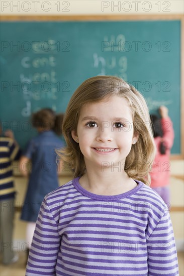Portrait of girl (6-7) in classroom. Photo: Rob Lewine