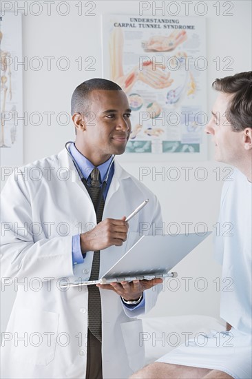 Male doctor talking to patient in hospital. Photo: Rob Lewine