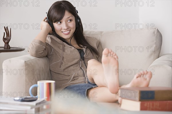 Young woman relaxing at sofa. Photo: Rob Lewine