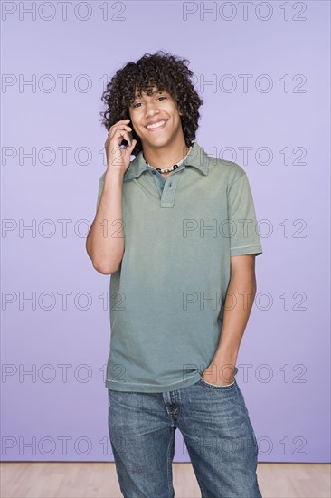 Portrait of teenage boy (14-15) talking on mobile phone. Photo: Rob Lewine