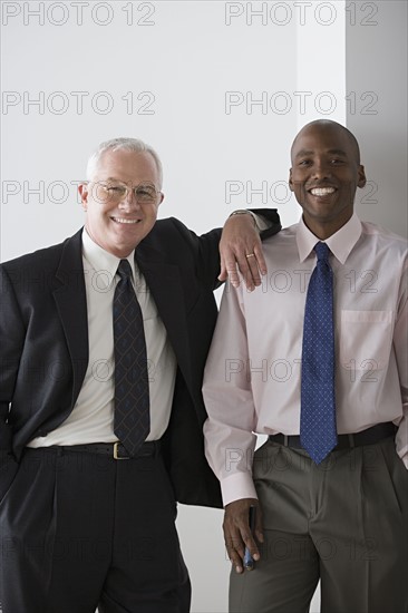 Two businessmen smiling. Photo: Rob Lewine