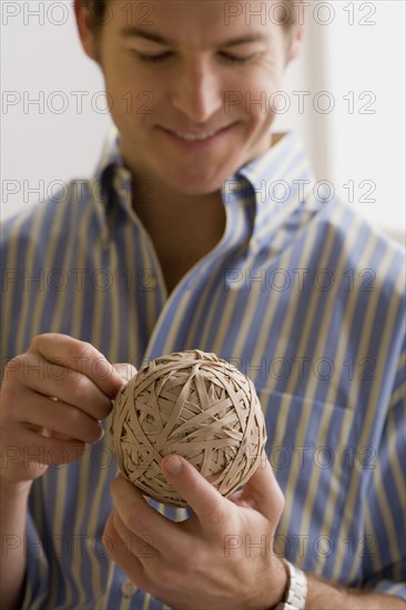 Young man holding ball made of paper. Photo: Rob Lewine