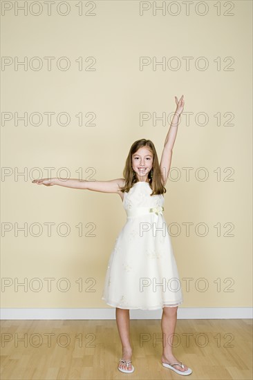 Portrait of happy girl (8-9) dressed in white. Photo : Rob Lewine