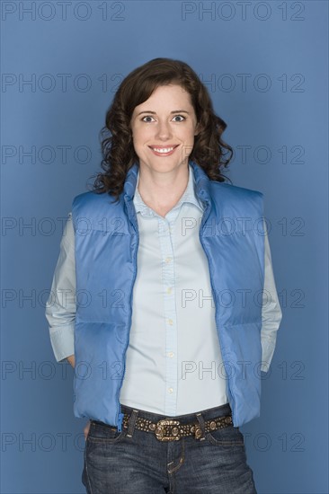 Portrait of happy mid adult woman wearing blue vest. Photo: Rob Lewine
