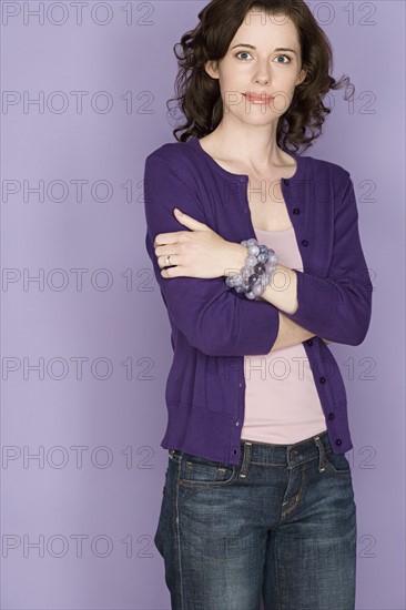 Portrait of smiling woman on purple background, studio shot. Photo: Rob Lewine
