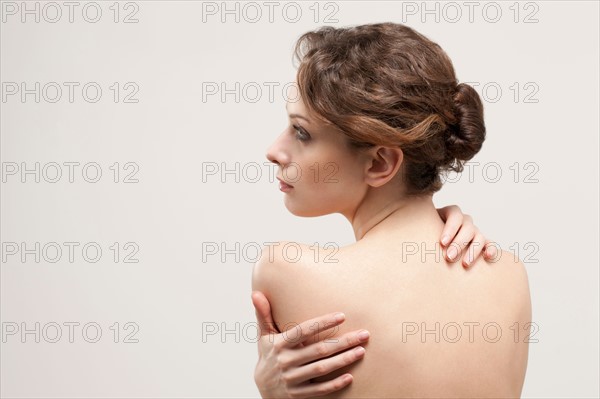 Rear view of beautiful young woman, studio shot. Photo : Jan Scherders