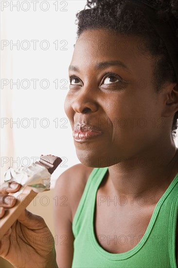 Woman eating chocolate bar. Photo : Rob Lewine