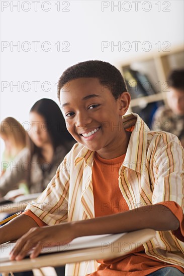 Schoolboy sitting in classroom. Photo : Rob Lewine