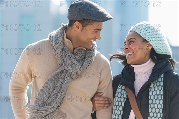 Couple walking in winter clothes.