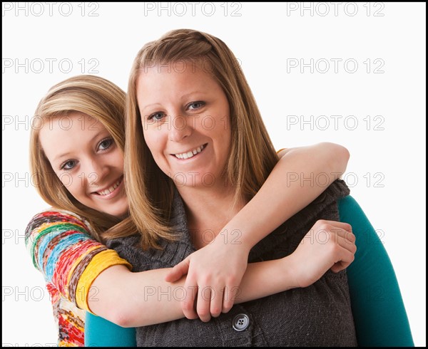 Studio shot of girl (12-13) with mother. Photo : Mike Kemp