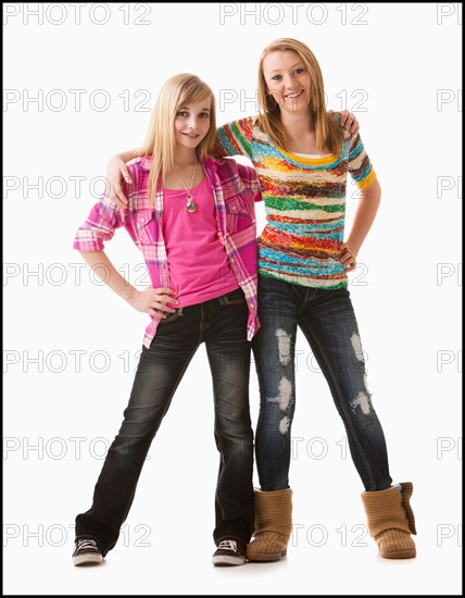 Studio shot of two happy girls (12-13). Photo : Mike Kemp