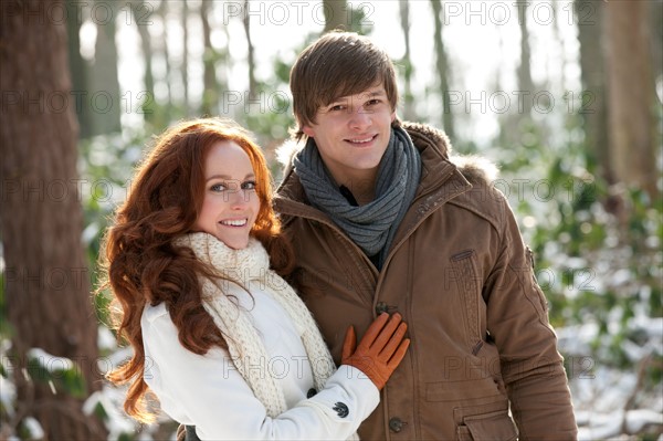 Netherlands, North-Brabant, Hilvarenbeek. Young couple embracing in winter scenery. Photo : Jan Scherders