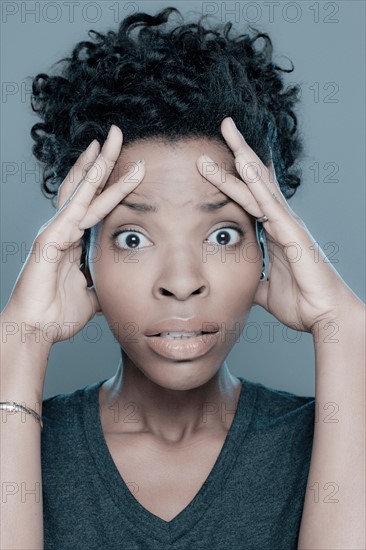 Studio shot of surprised young woman. Photo : Rob Lewine