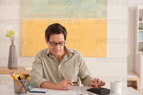 Man doing paperwork. Photo : Rob Lewine