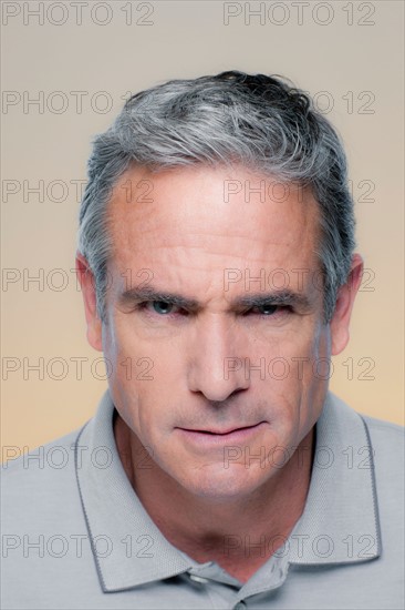 Studio Portrait of mature man staring at camera. Photo : Rob Lewine