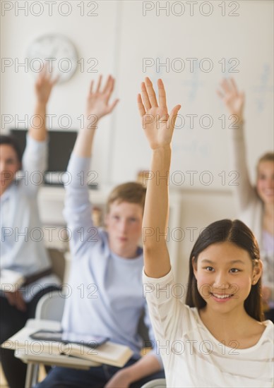 Students (14-19) raising hands.